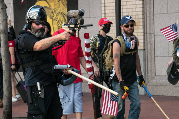 PORTLAND%2C+OR+-+AUGUST+15+%3A+The+Proud+Boys%2C+an+alt-right+group%2C+faces+off+against+Black+Lives+Matters+protesters+using+mace+and+a+paint+ball+gun+on+August+15%2C+2020+in+downtown+Portland%2C+Oregon.+Demonstrations+have+occurred+on+almost+a+nightly+basis+in+Portland+since+the+killing+of+George+Floyd.+%28Photo+by+Paula+Bronstein%2FGetty+Images+%29