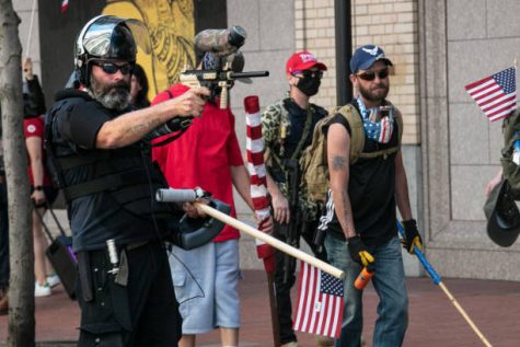 PORTLAND, OR - AUGUST 15 : The Proud Boys, an alt-right group, faces off against Black Lives Matters protesters using mace and a paint ball gun on August 15, 2020 in downtown Portland, Oregon. Demonstrations have occurred on almost a nightly basis in Portland since the killing of George Floyd. (Photo by Paula Bronstein/Getty Images )