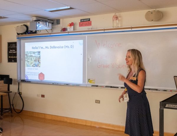 Mrs. Devon DeBevoise gives a PowerPoint presentation for parents to get to know her and the students’ activities in Science 8.