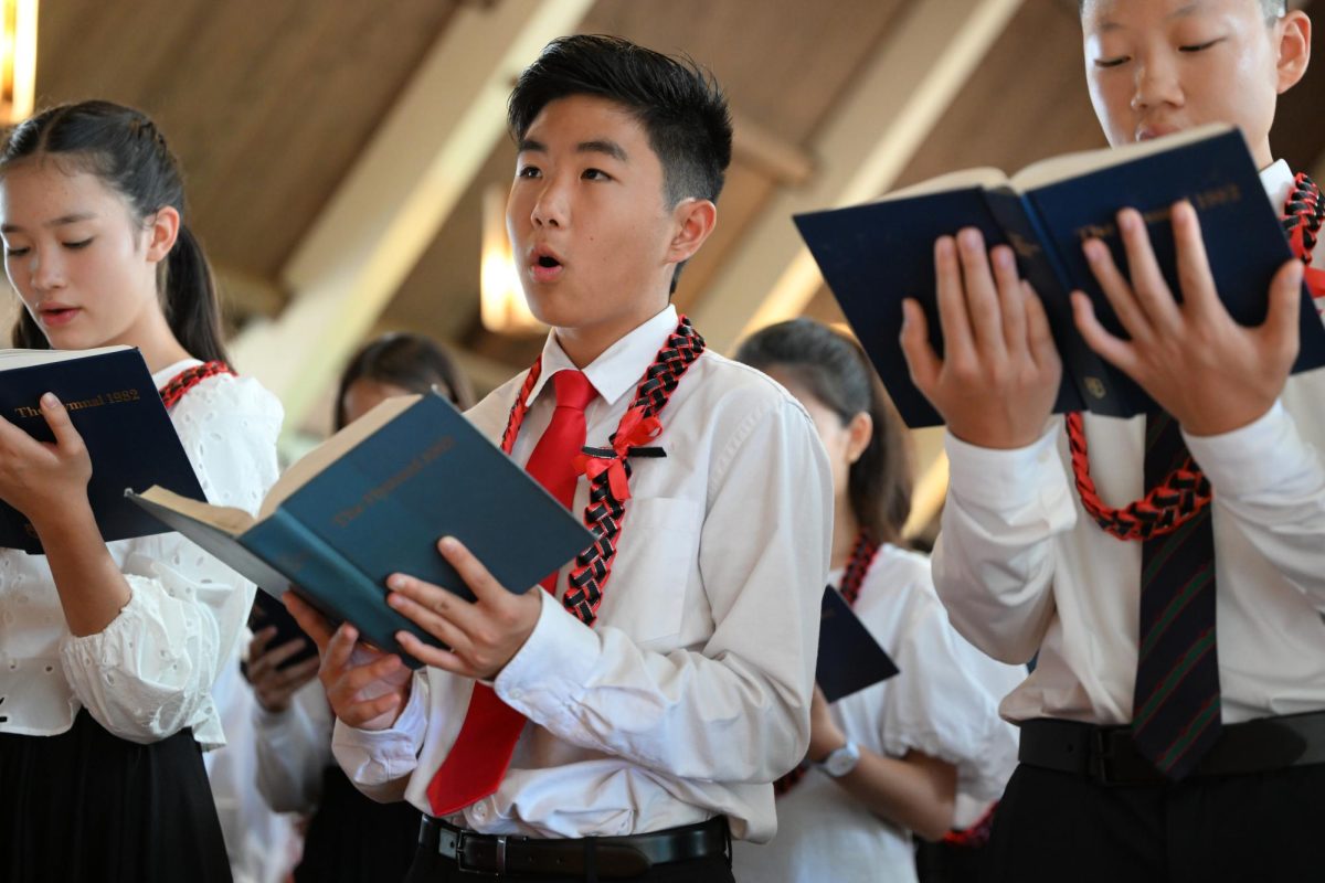 Cole+K.+%E2%80%9929+joins+his+class+as+they+sing+a+hymnal+song.+Photo+courtesy+of+Mr.+John+Tamanaha.+