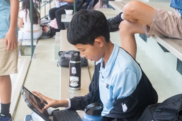 Kaito Shimamoto ’30 focuses on his schoolwork during lunch.