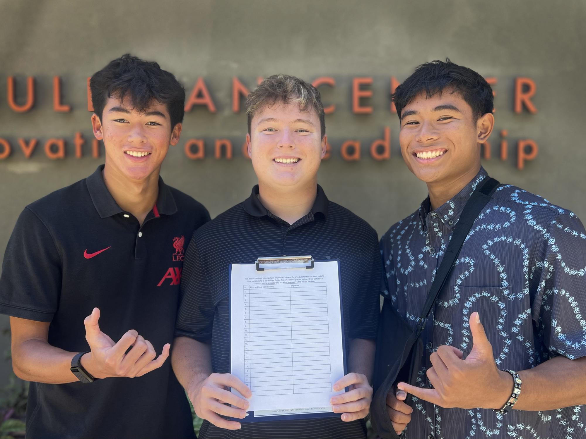 Nicolas M. '26, Kai C. '26, and CJ V. '26 (Left to right), spearheads of the senior shirt conversation, holding one of the petition papers presented to Ms. Yoneda at the meeting. 