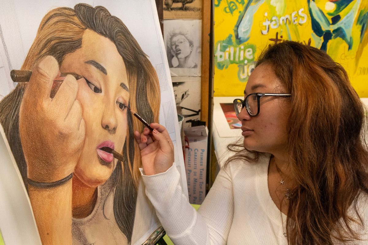 Kassidy M. ’26 touches up a piece of hers in AP Drawing.
